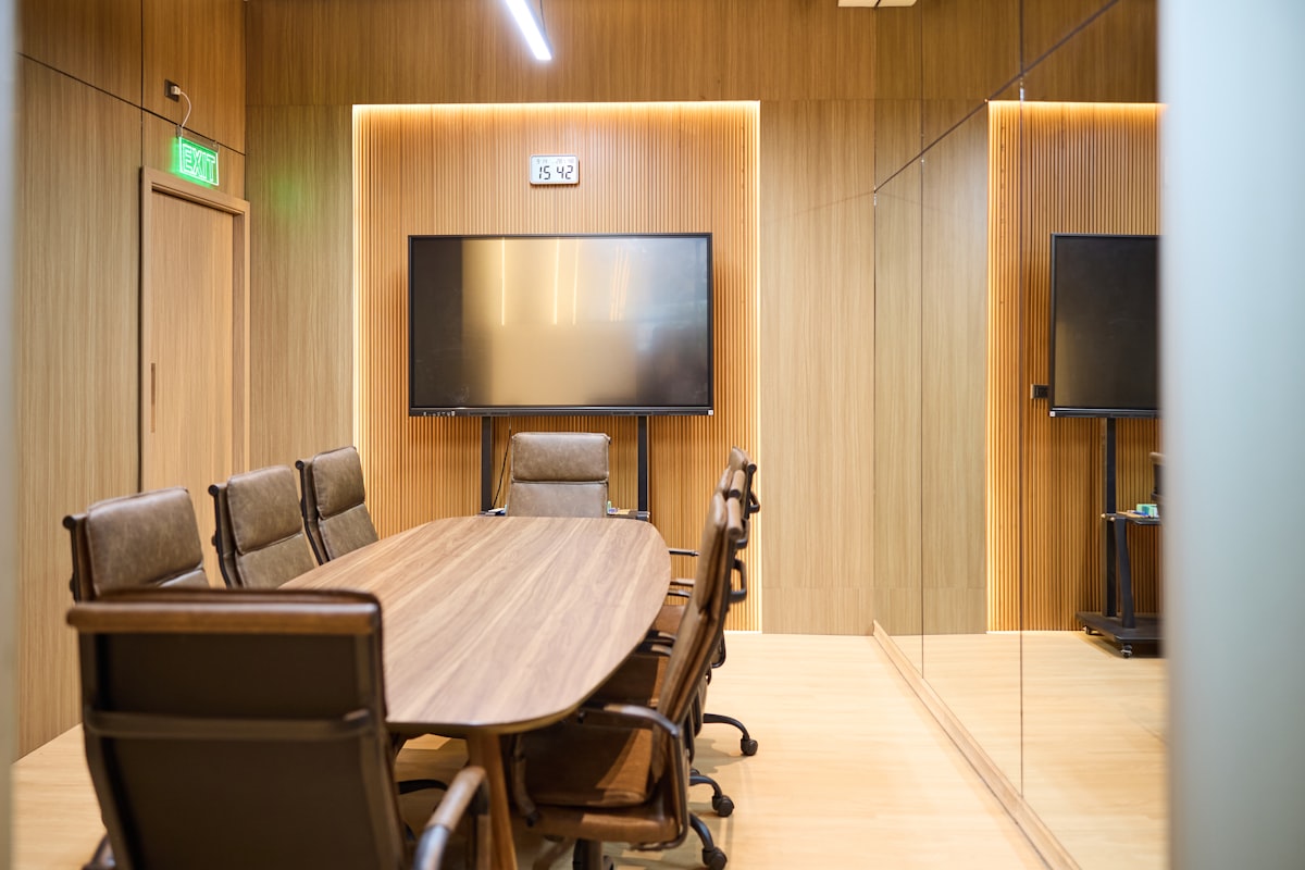 Modern premium conference room with wall screen and automated lighting