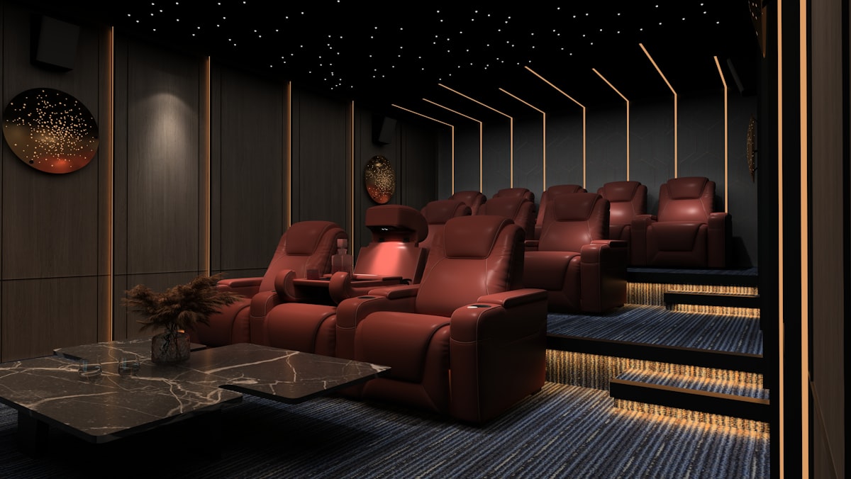 Luxury dark home theatre with recliner seating and ambient lighting